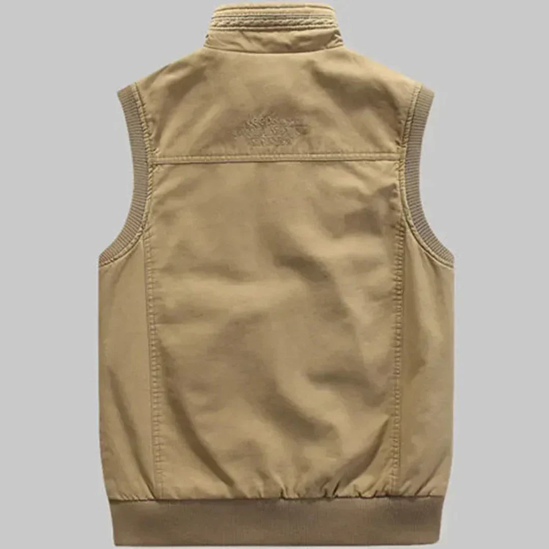 Green men's travel vest with multiple pockets. Sleeveless casual vest, great for outdoor adventures & utility.