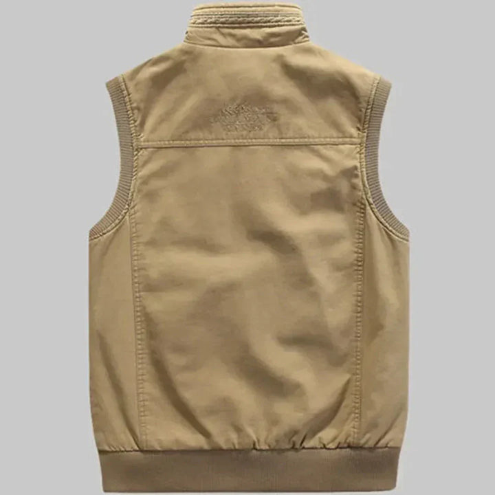 Green men's travel vest with multiple pockets. Sleeveless casual vest, great for outdoor adventures & utility.