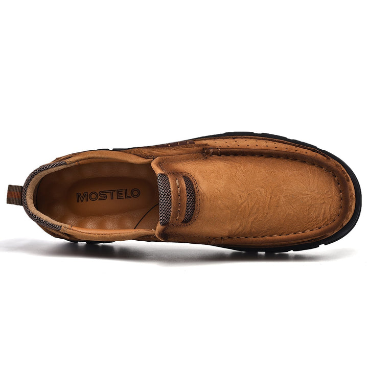 Detail of the comfortable sole on men's brown orthopedic transition boots, slip-resistant pattern.