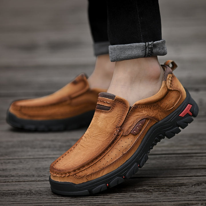 Men's brown orthopedic boots, comfortable sole, on a city street, showcasing urban style and support.