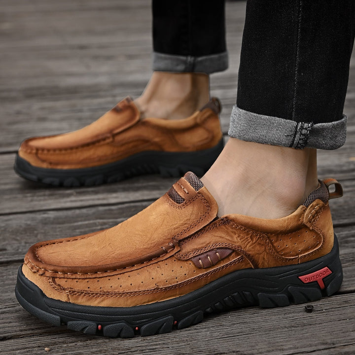 Close-up of the slip-resistant sole of khaki orthopedic men's boots, comfortable and secure.