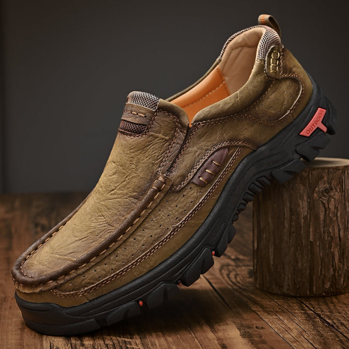 Men's brown orthopedic boots, close-up of stitching detail, comfortable, high-quality leather.