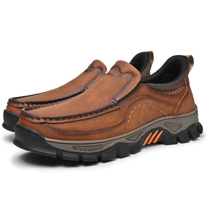 Pair of men's casual orthopedic leather slip-on walking shoes on white background
