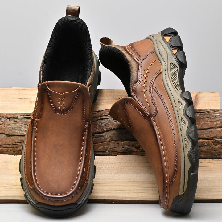 Grey men's orthopedic leather slip-ons, offering comfort for walking and casual outings