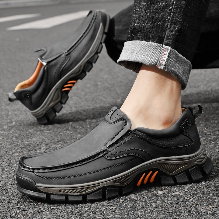 Orthopedic men's boots in a modern office, comfortable black footwear, dress casual
