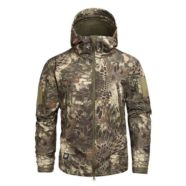 Men's hooded camouflage jacket in a forest setting, showcasing its earthy camo print