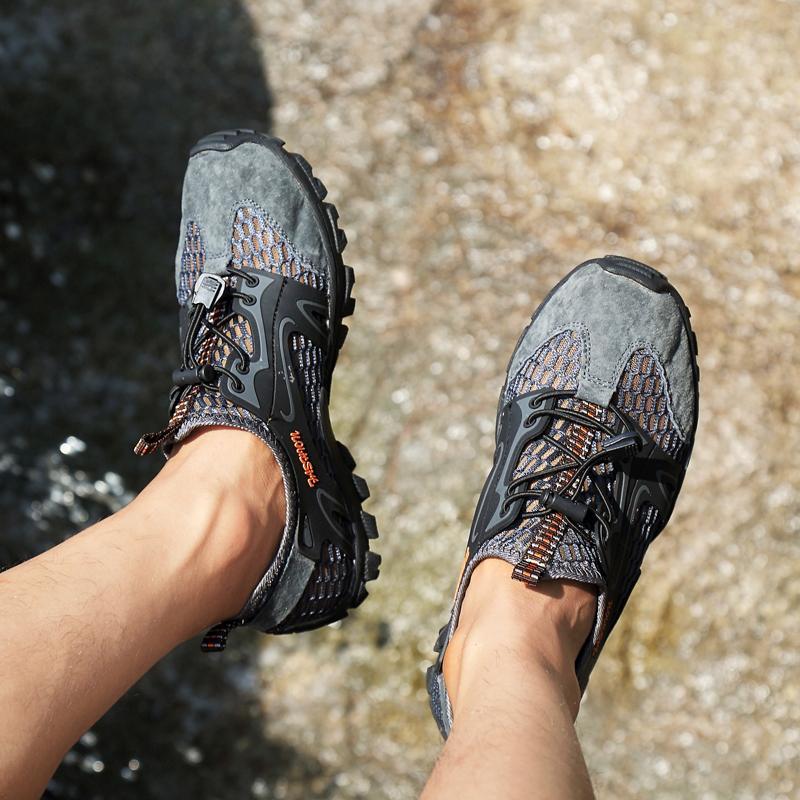Close-up of the sole of men's trail running shoes, showing multi-directional lugs for grip