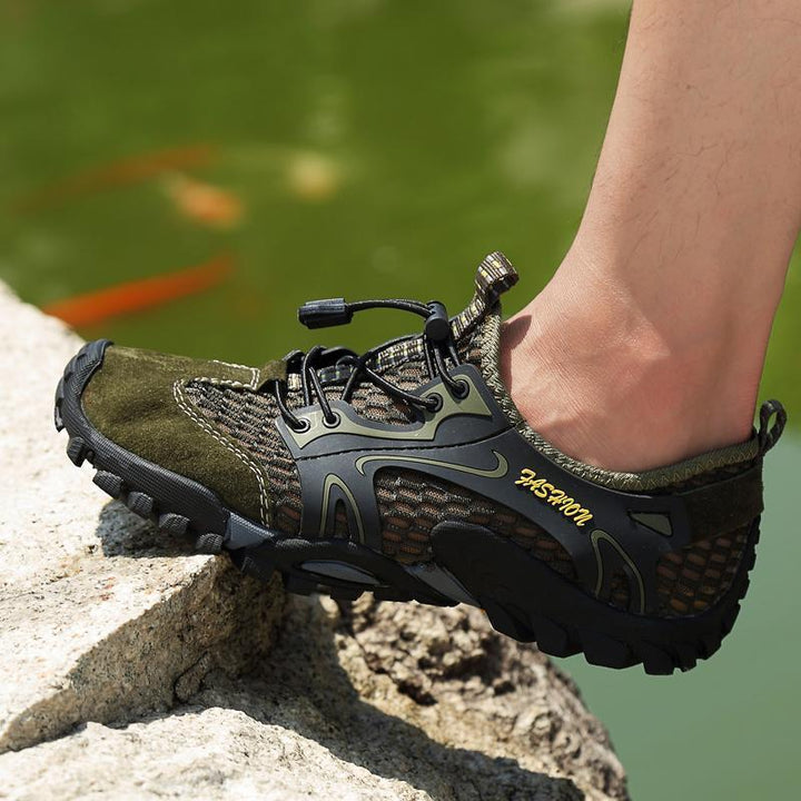 Men's outdoor hiking shoes displayed with hiking gear, ready for a challenging trek