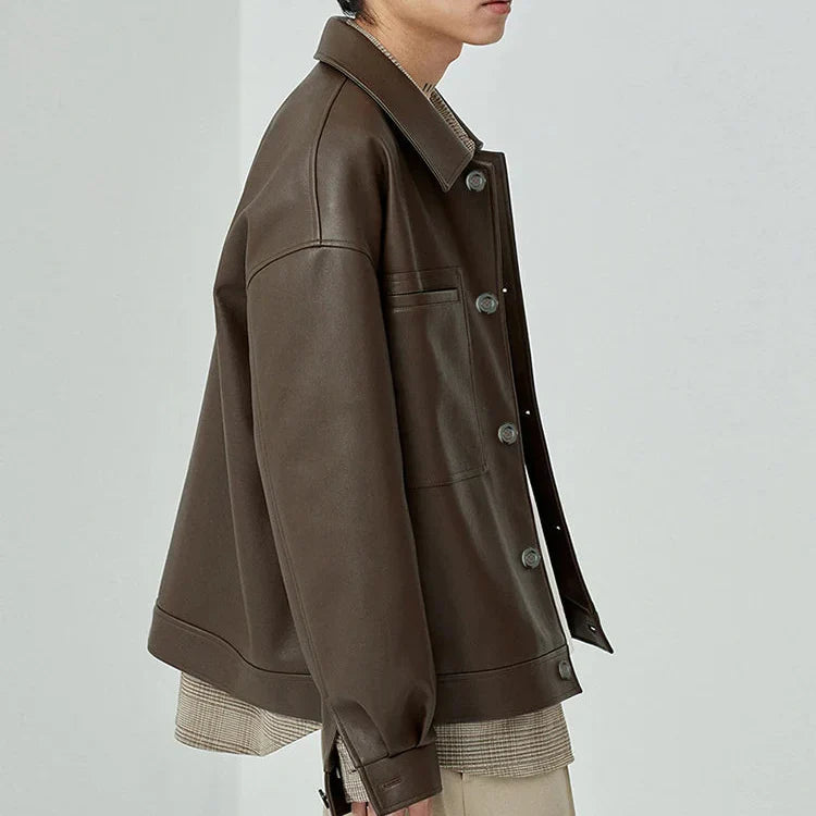 Close-up of the textured faux leather on a men's oversized jacket, highlighting material detail