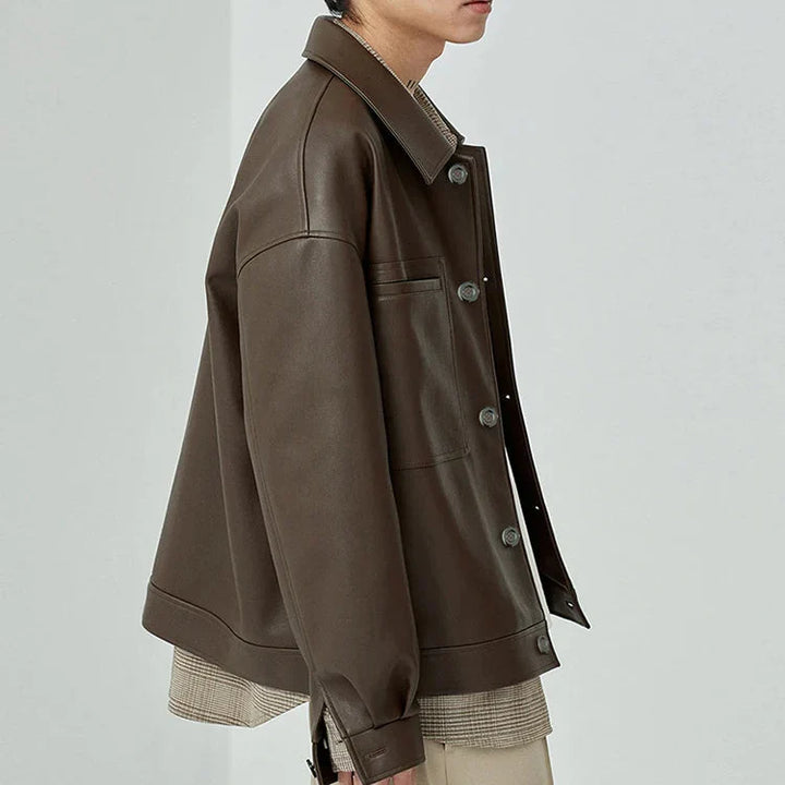 Close-up of the textured faux leather on a men's oversized jacket, highlighting material detail