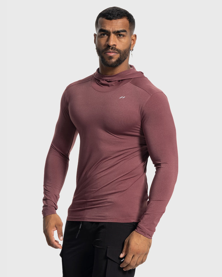 Male model wearing a grey performance hoodie, running outdoors, showcasing stretch fabric