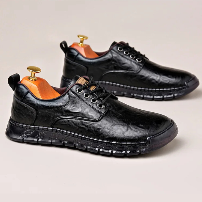 Close-up of men's polished black leather dress shoe, showcasing oxford detailing and hybrid sole.