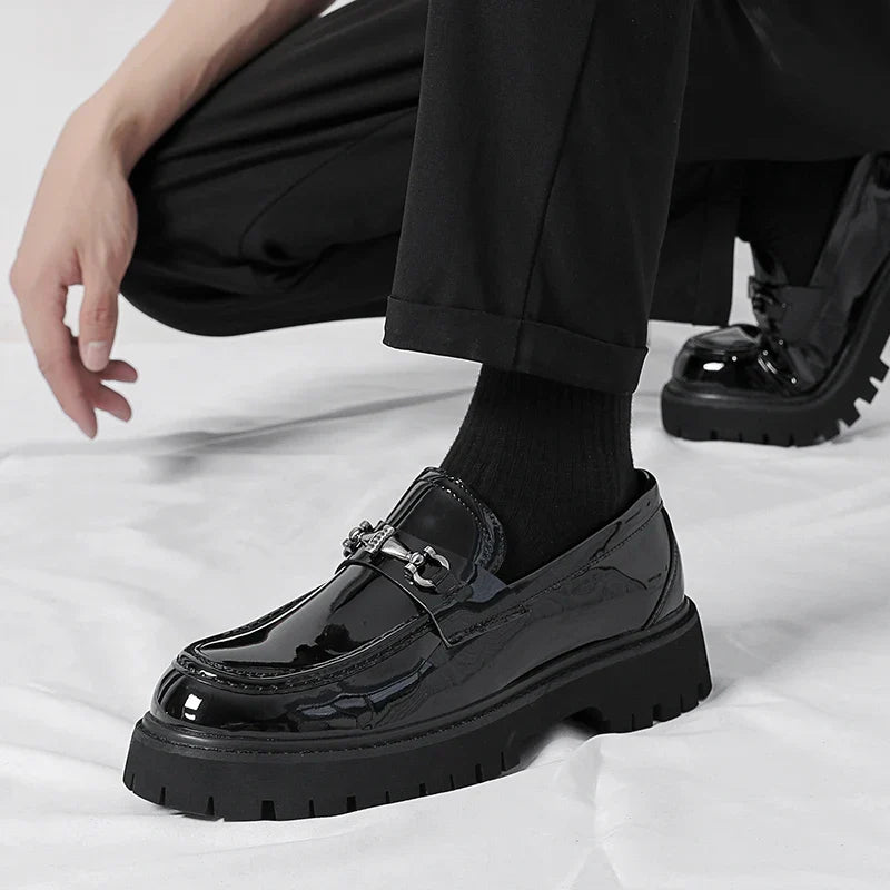 Front view of black polished men's dress loafers, professional and elegant slip-on formal footwear.