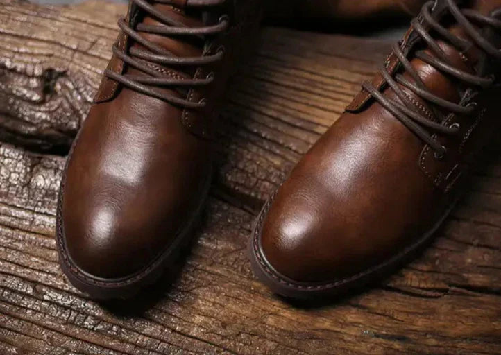 Side view of men's brown leather boots, highlighting the robust design and cushioned interior