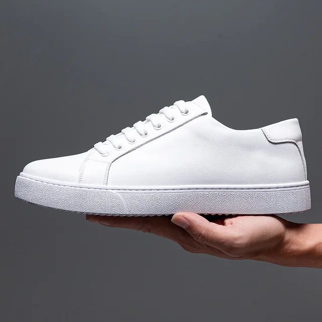 Side profile of men's white leather casual sneakers, clean design, versatile & comfortable