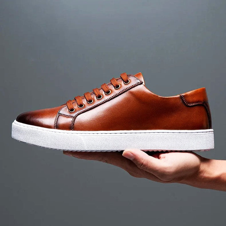 Man wearing men's premium leather sneakers with jeans, stylish casual footwear everyday