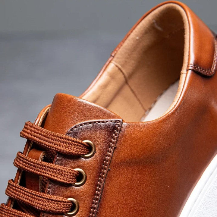 Top-down view of men's gray leather casual sneakers, minimalist design, comfortable fit