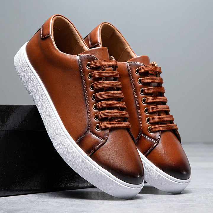 Men's leather sneakers on a wooden floor, showcasing versatile casual footwear style