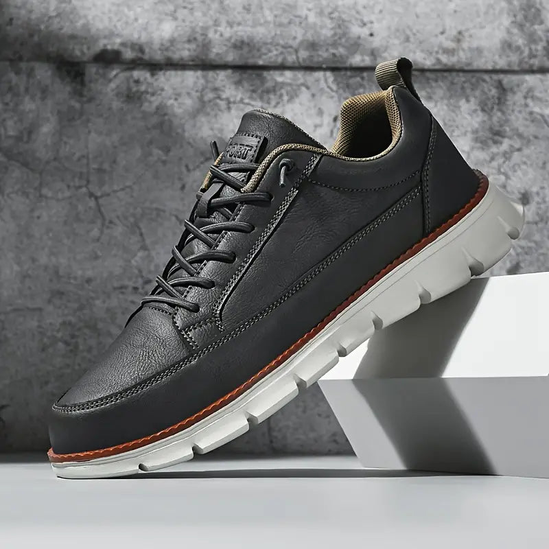 Close-up of men's black leather casual sneakers with white sole, stylish everyday footwear