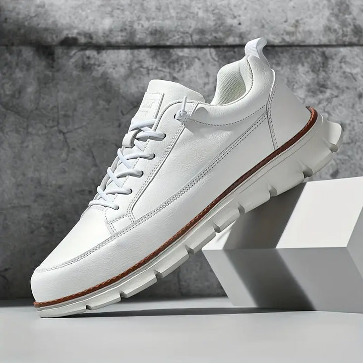 Pair of men's premium leather casual sneakers in tan, front view, versatile athletic shoes