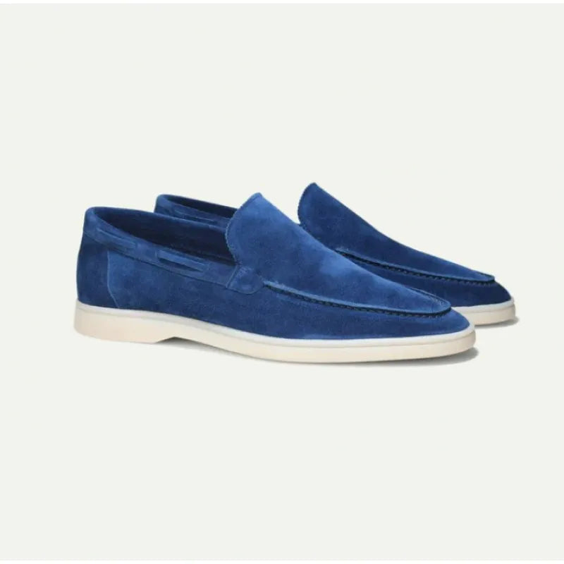 A pair of men's navy blue suede slip-on loafers, versatile for casual wear and smart occasions, comfortable.