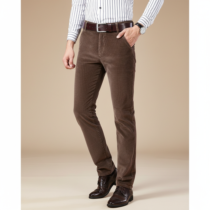 Detail of the button and zip closure on premium men's corduroy tailored trousers, emphasizing quality.