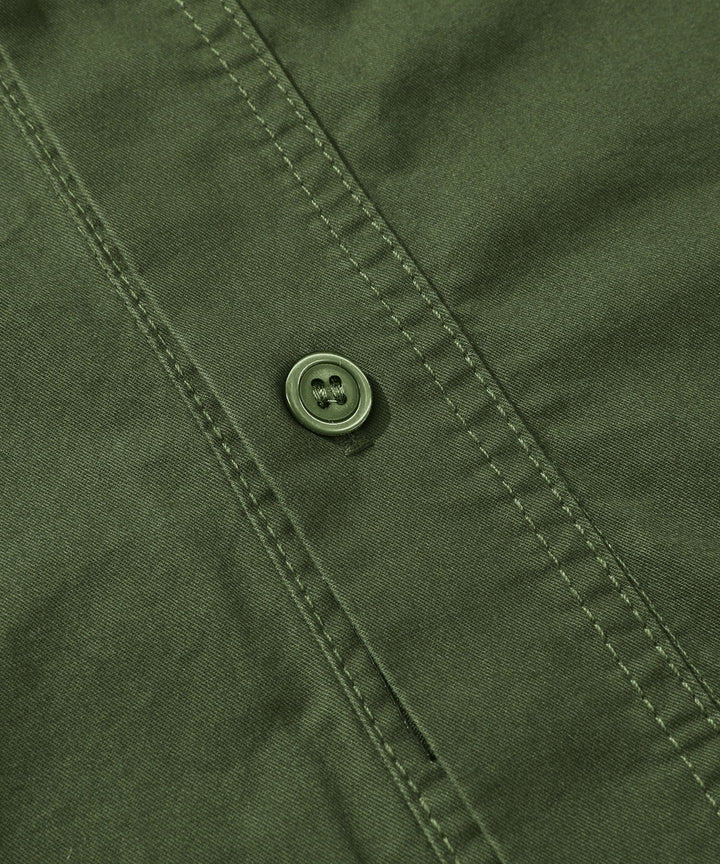 Lifestyle shot of a man enjoying comfort in his Men's Premium Cotton Terrain Trek Shirt outdoors.
