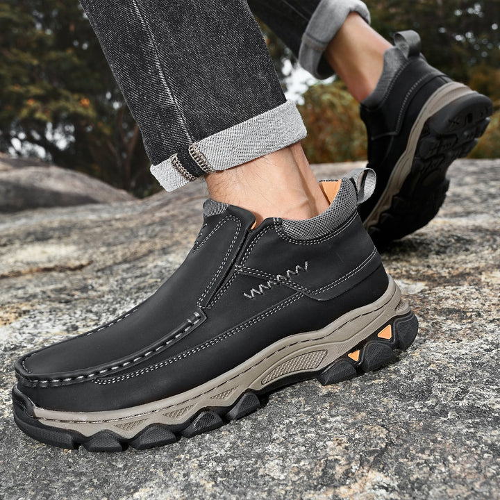 Two pairs of men's premium leather slip-on walking shoes, one brown, one black, casual and orthopedic