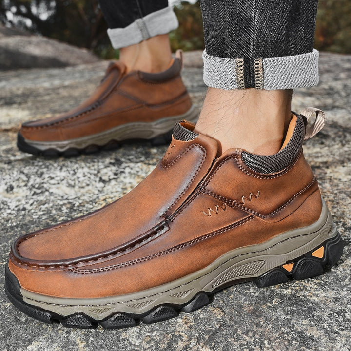 Pair of men's orthopedic slip-on shoes in dark brown leather, ideal for casual outdoor wear