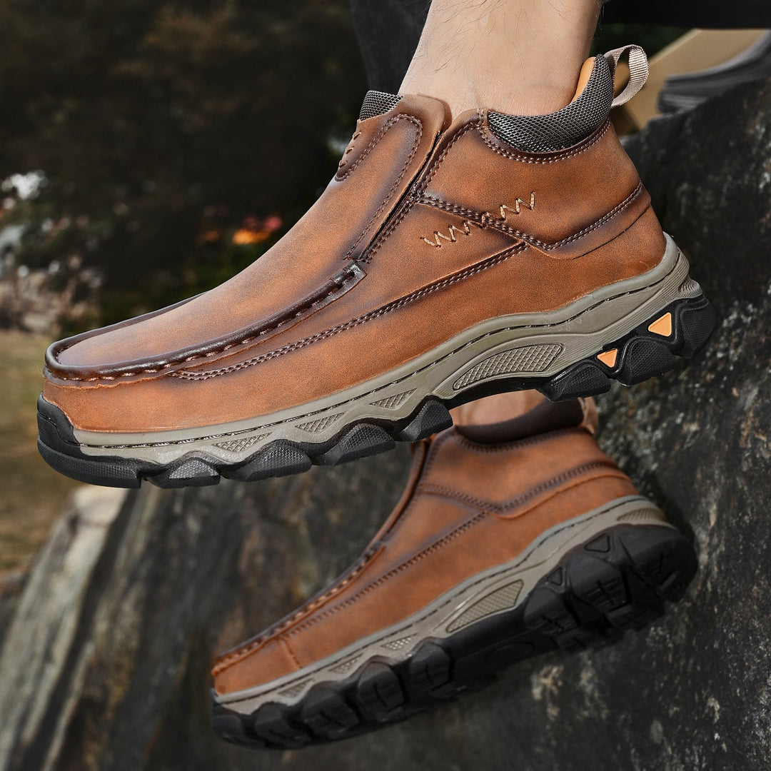 Angled shot of men's casual slip-on shoes, light brown leather, with durable non-slip sole