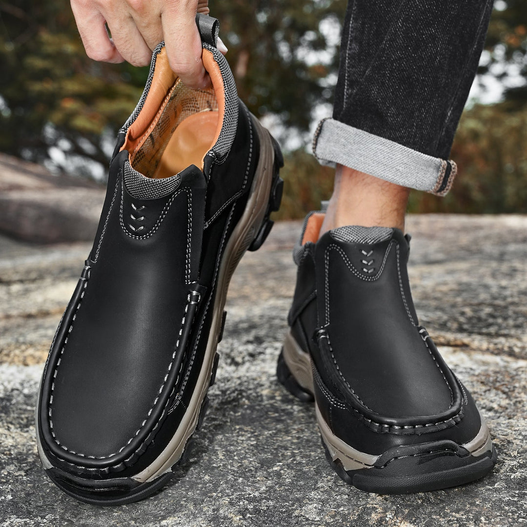 Close-up of the textured premium leather on men's slip-on walking shoes, tan color