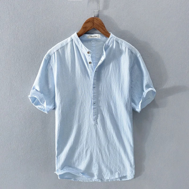 Close-up of the textured fabric of a men's breathable linen blend shirt for warm weather.