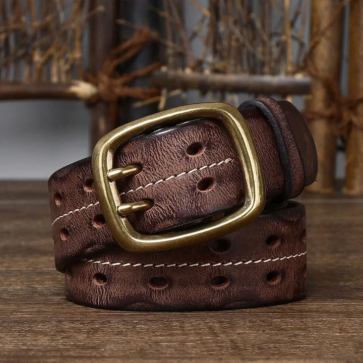 Close-up of a rugged men's cowhide leather belt, showcasing the rich texture and brass buckle