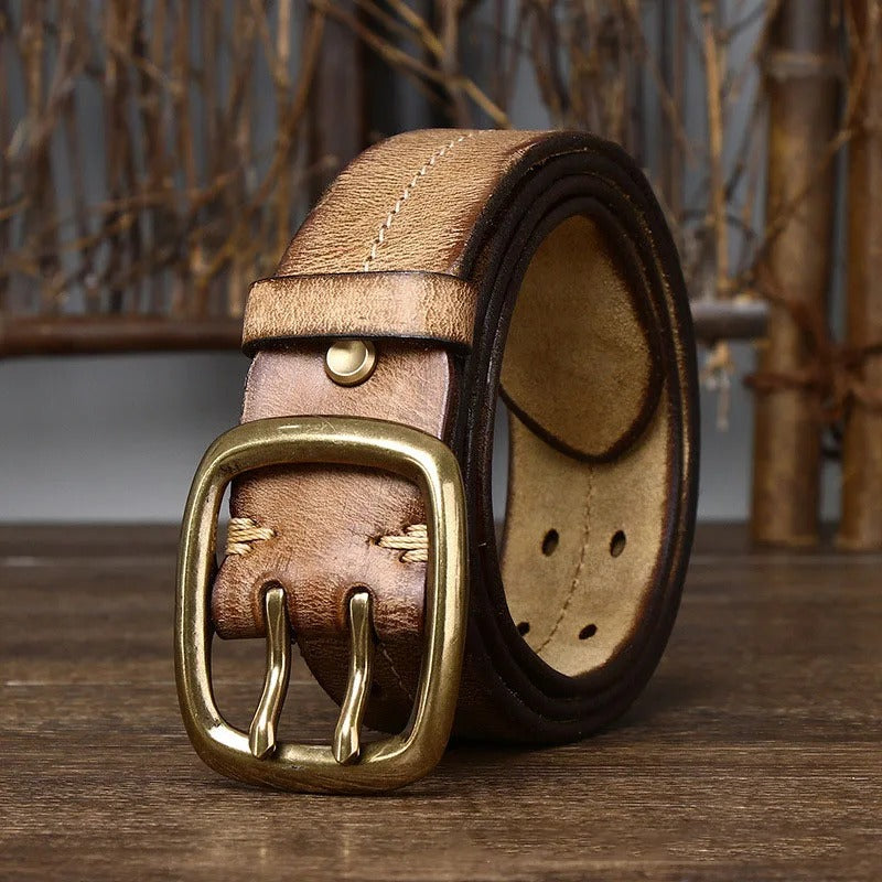A stack of durable men's cowhide leather belts in various colors, all with brass buckles