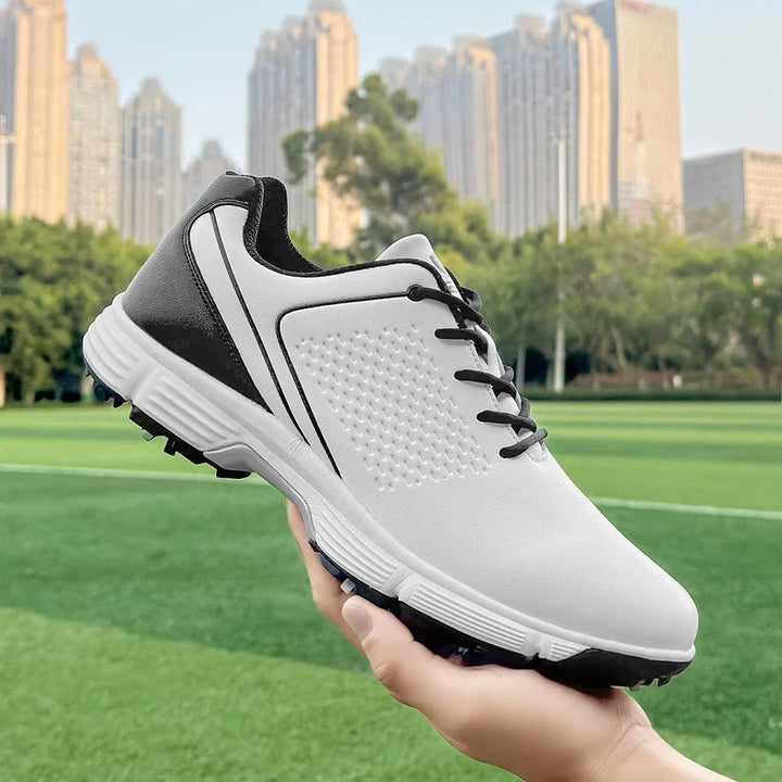 Blue accents on blackout men's spiked golf shoes, combining style with pro-level functionality.