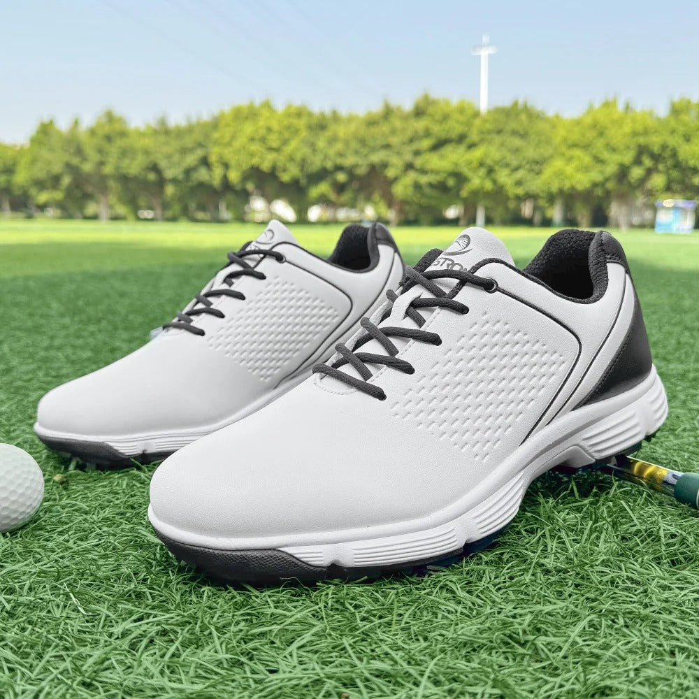Men's blackout golf shoes with blue highlights, performance spikes, & water-resistant leather.