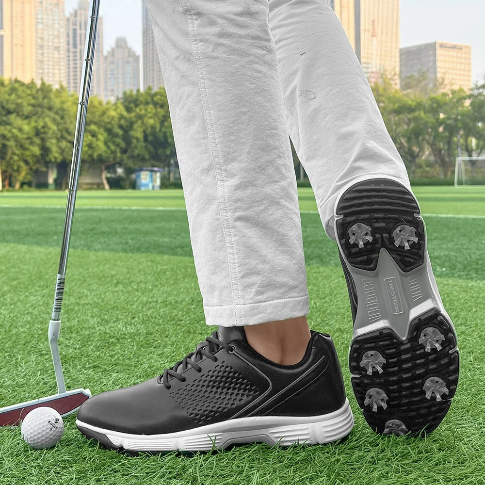 Spiked men's golf footwear in blackout, providing excellent traction and support.