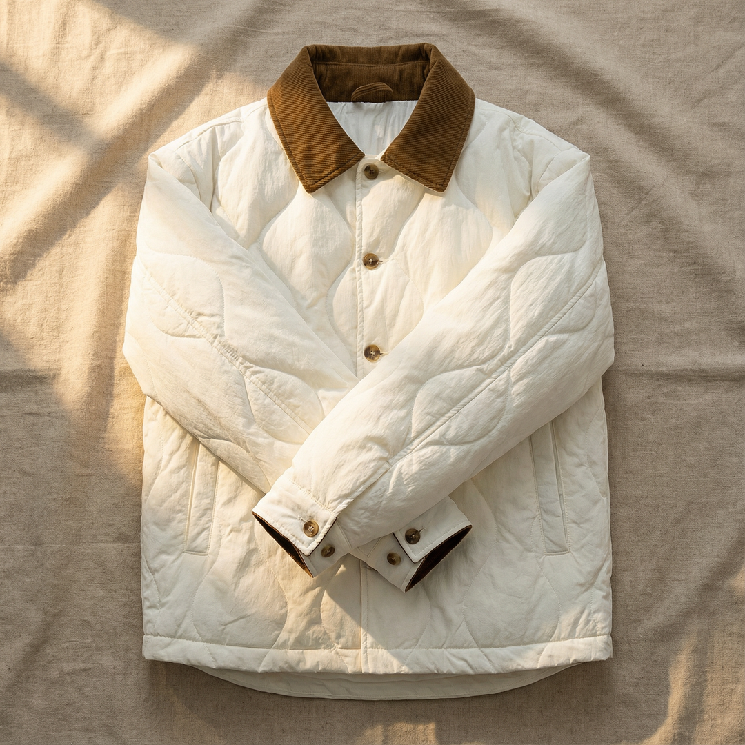Close-up of the quilted cotton fabric on a men's durable winter jacket with a corduroy collar