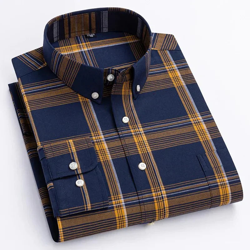 Close-up of a men's blue and green plaid long sleeve button-down shirt fabric, showing texture and pattern.