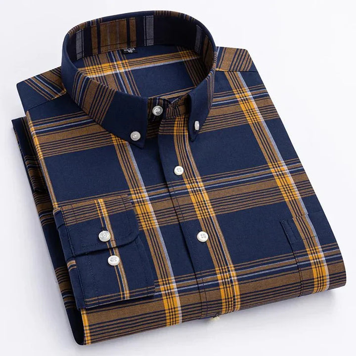 Close-up of a men's blue and green plaid long sleeve button-down shirt fabric, showing texture and pattern.