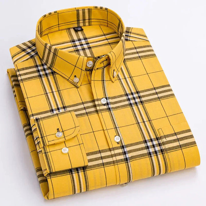 Detail of the collar and buttons on a men's classic plaid long sleeve button-down shirt in a rich color.