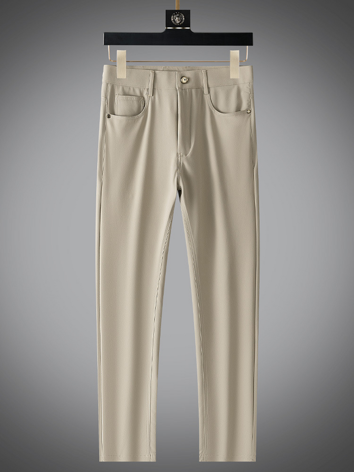Detailed view of the waistband and pockets on men's refined matte finish beige pants.