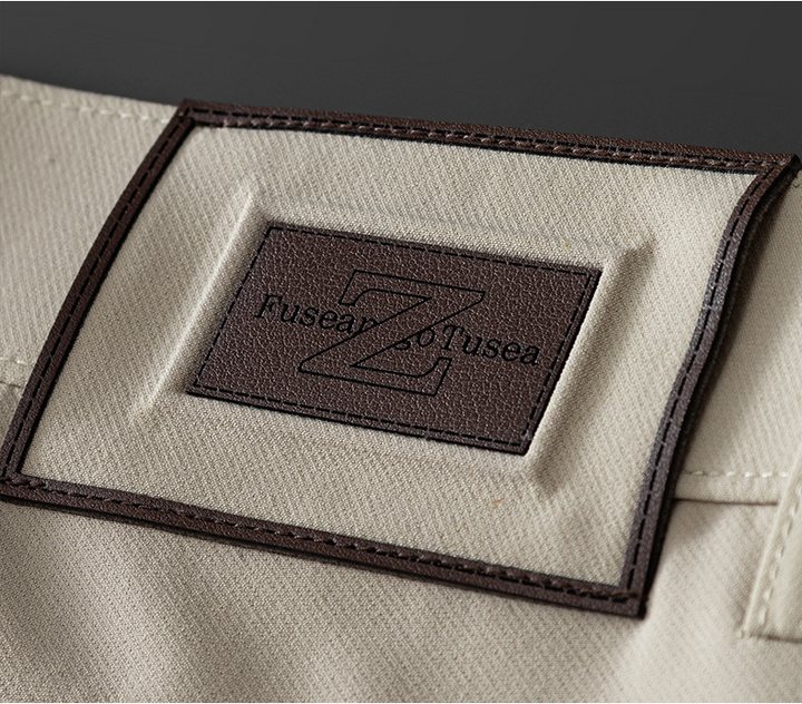 Full-length image of men's matte finish beige trousers, showcasing their sophisticated drape.