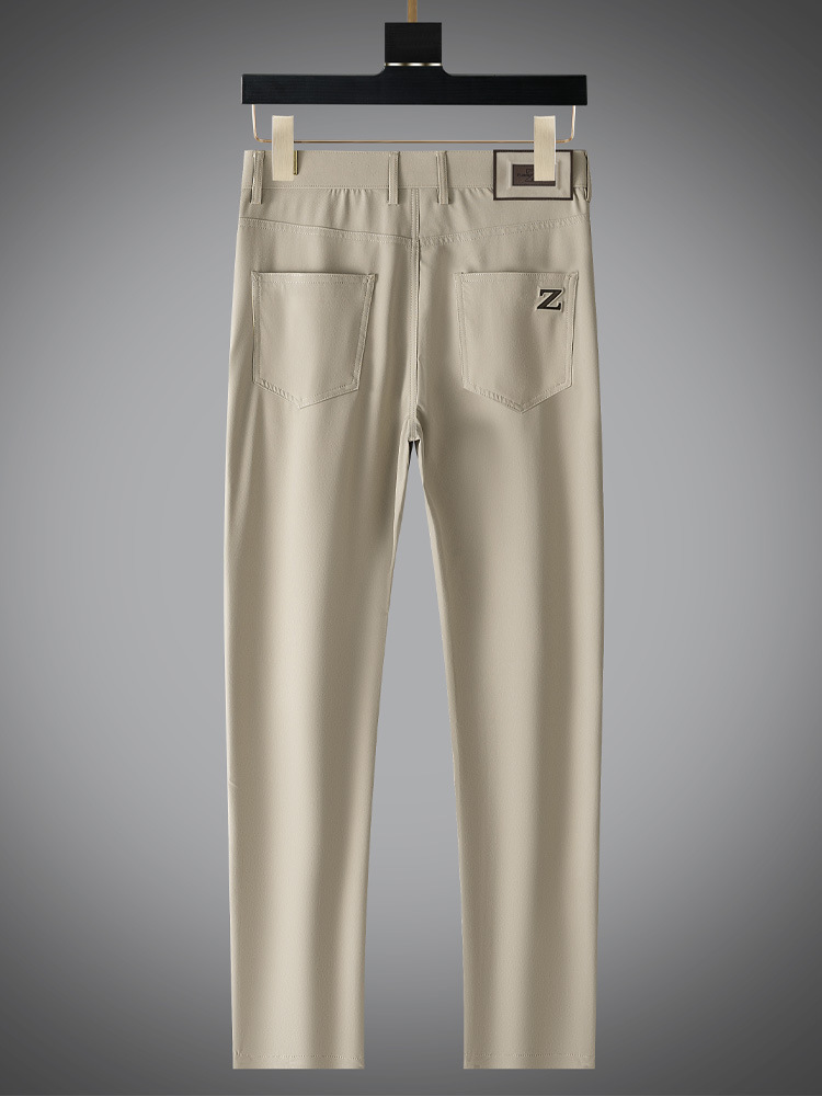 Model wearing men's beige matte trousers, styled for a contemporary and refined appearance.