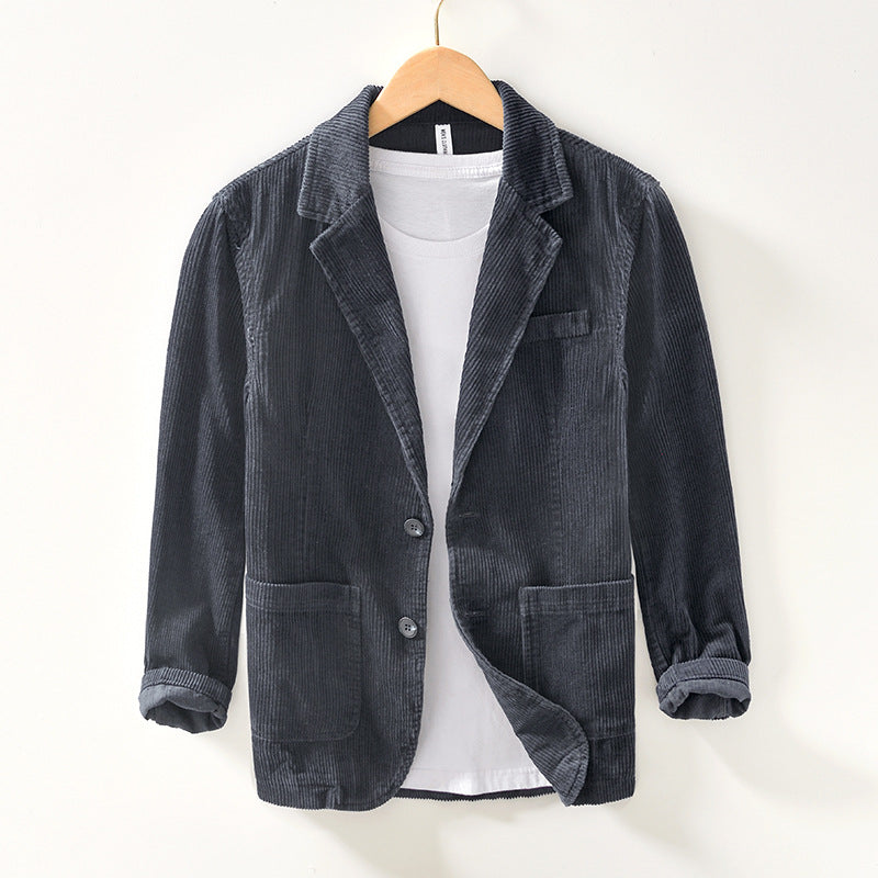 Close-up of the textured corduroy fabric on a men's relaxed fit gray blazer