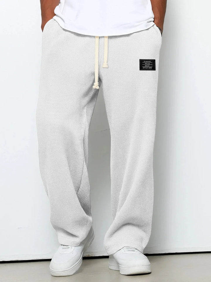 Stylish men's purple relaxed fit lounge pants. Waffle knit fabric & drawstring waist offer ultimate casual comfort.