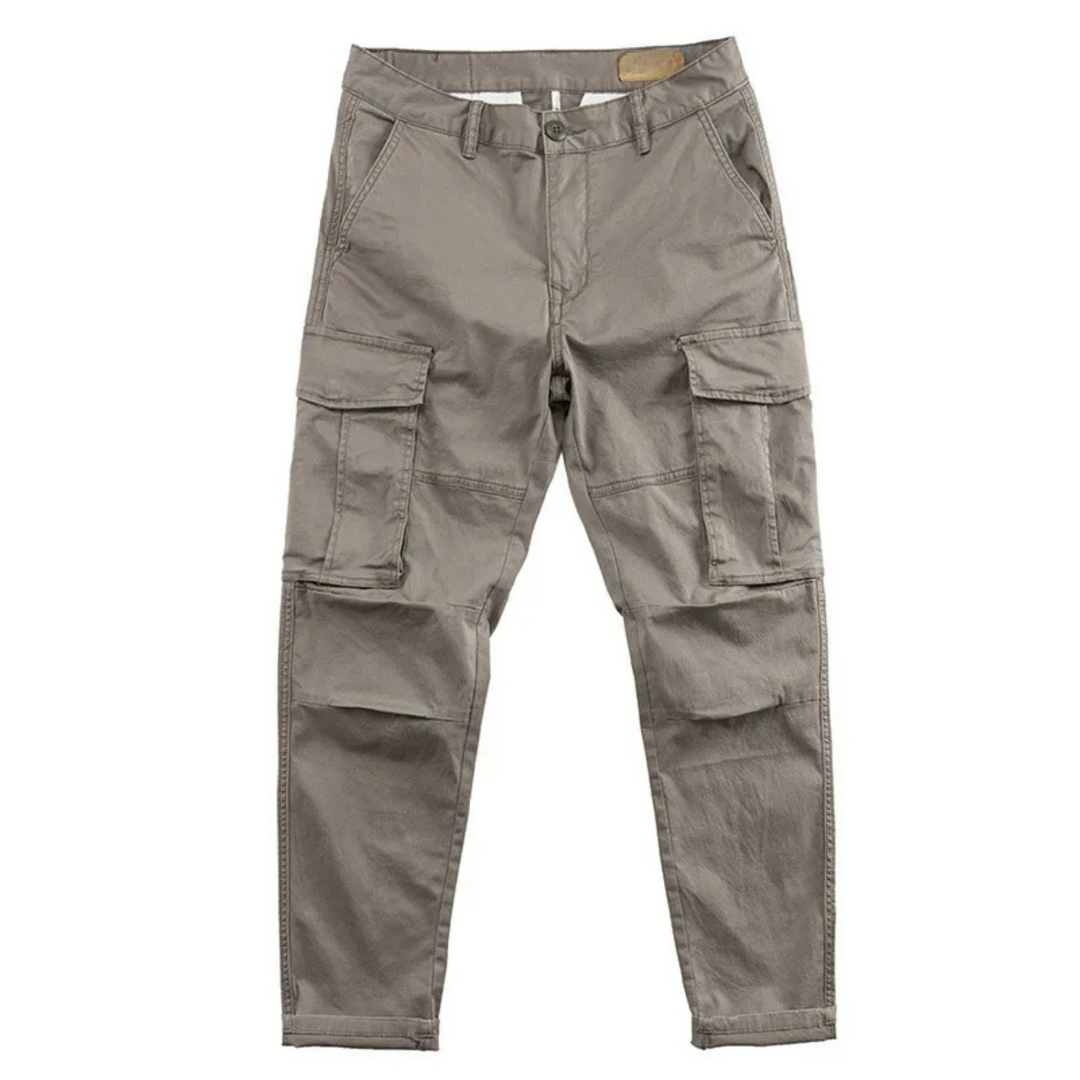 Close-up of a men's relaxed fit cargo pant pocket, highlighting stitching and button closure.