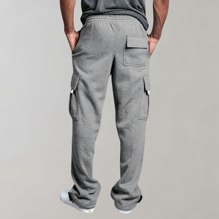Close-up of grey men's relaxed fit tactical cargo pants with multiple pockets for utility.