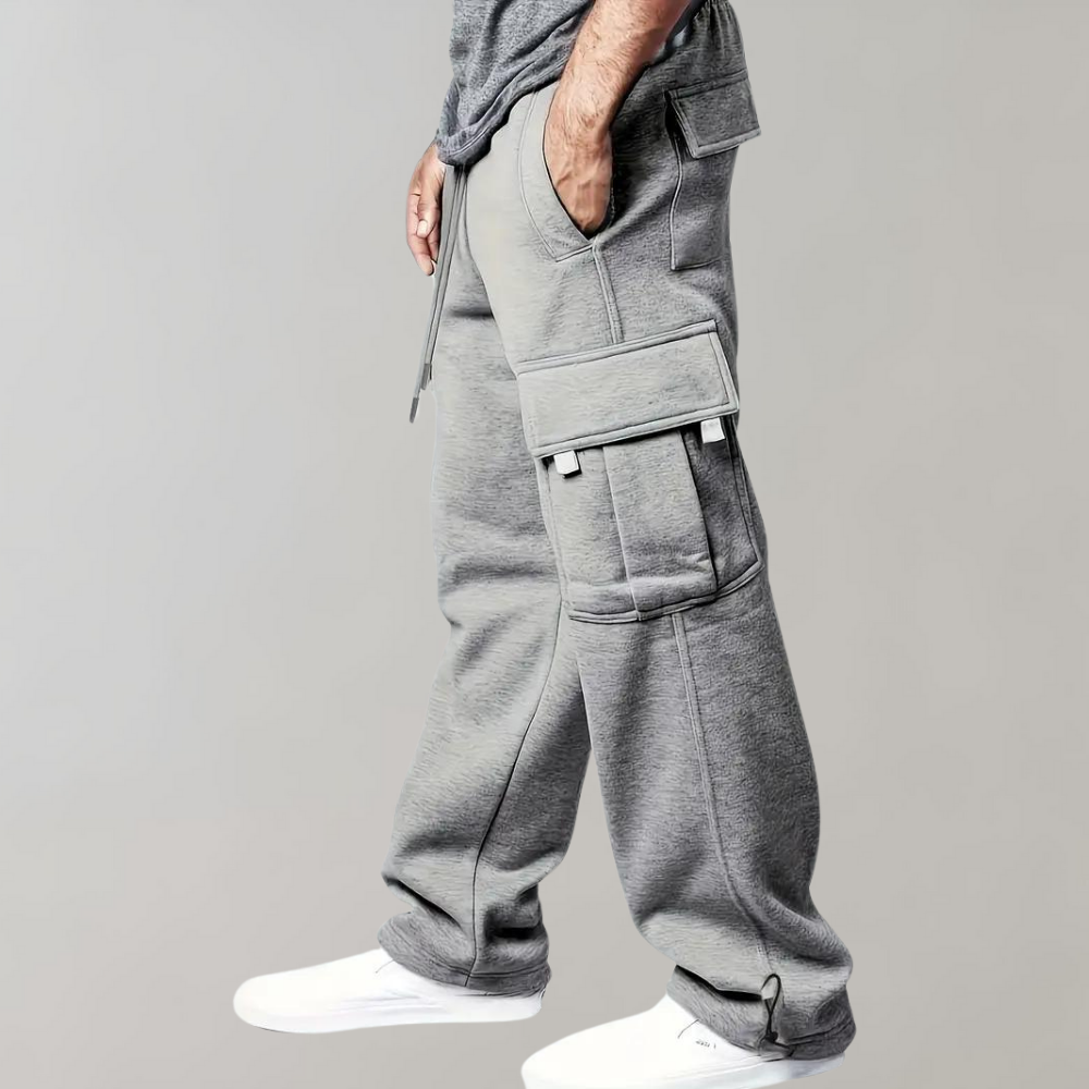 Model wearing black men's relaxed fit tactical cargo pants for a modern streetwear look.