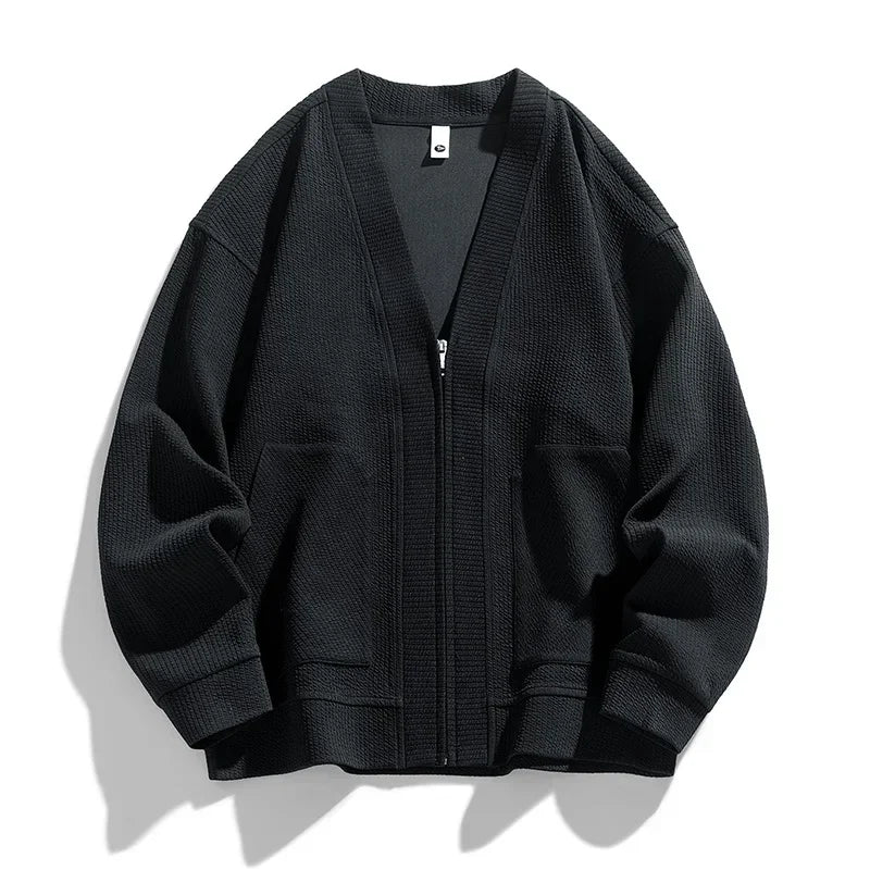 Close-up of the textured knit detail on a men's relaxed fit zip-up cardigan.